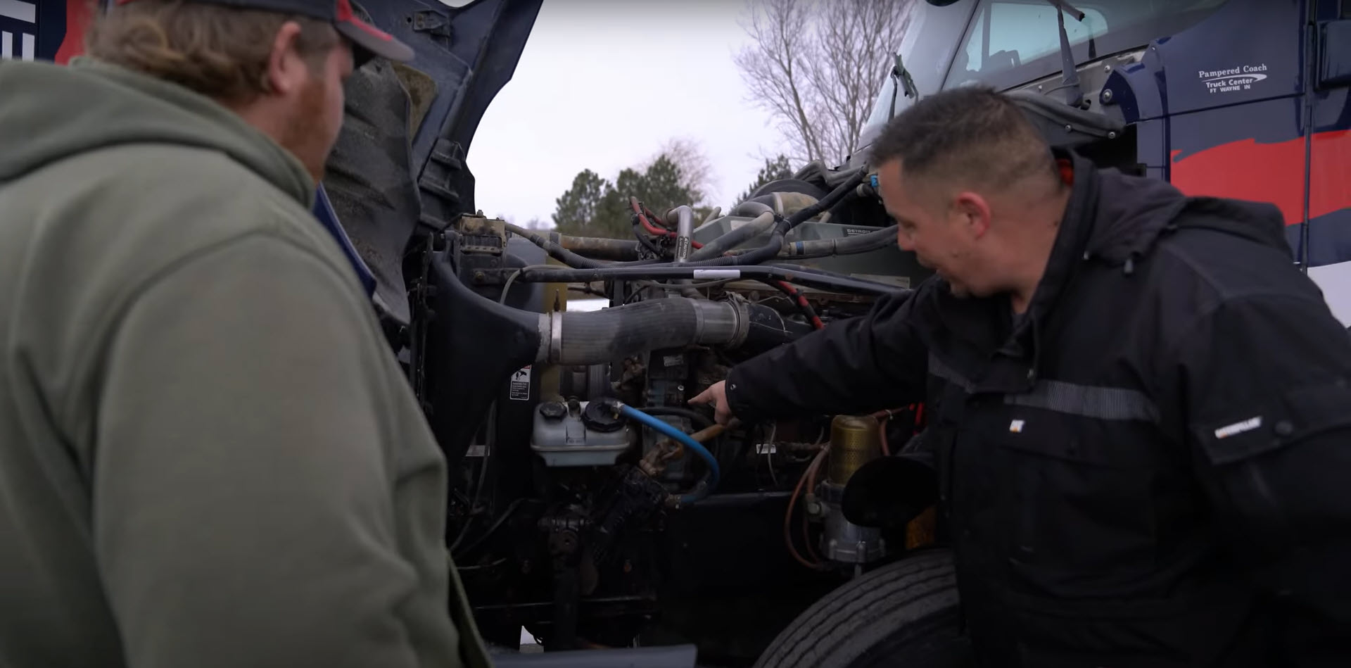 Student working on car engine