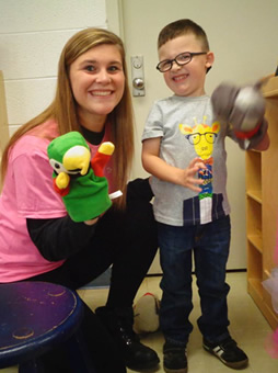Students playing puppets
