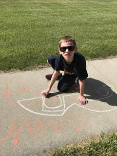 Student drawing with chalk